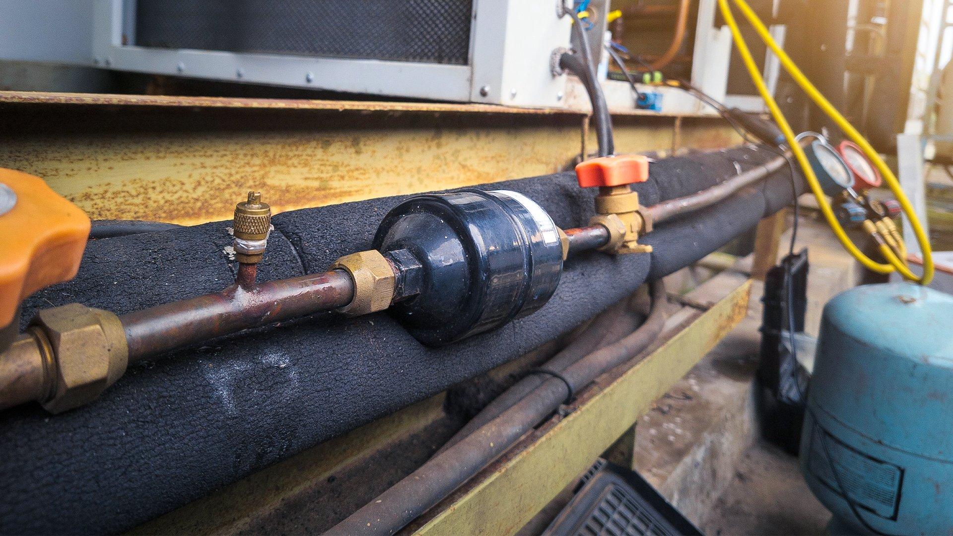 Close up image of filter drier installed on residential unit. 